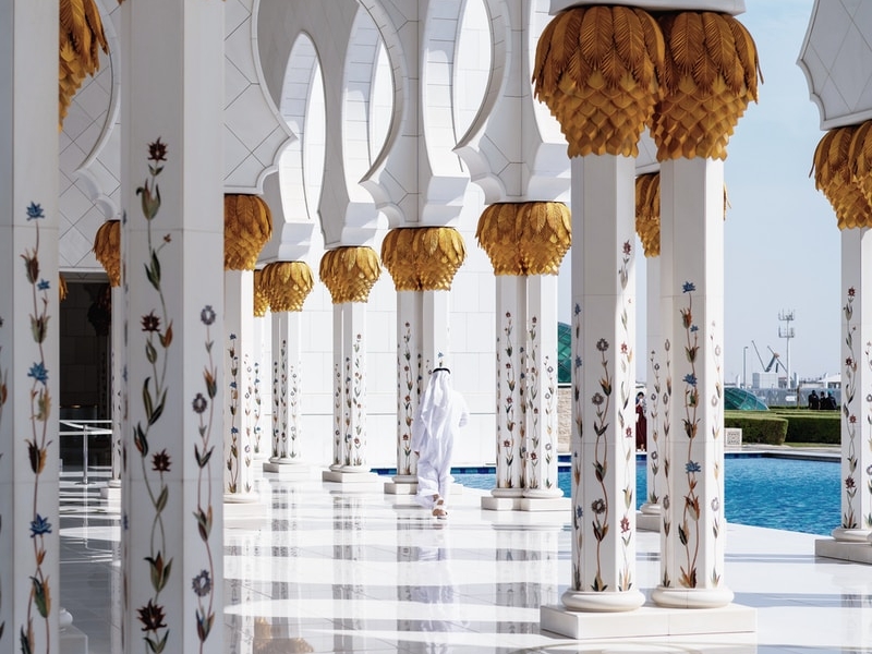 white and gold temple beside pool